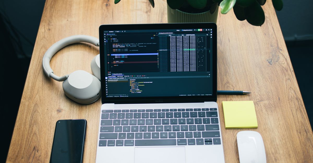 Minimal developer workspace with a laptop and headphones